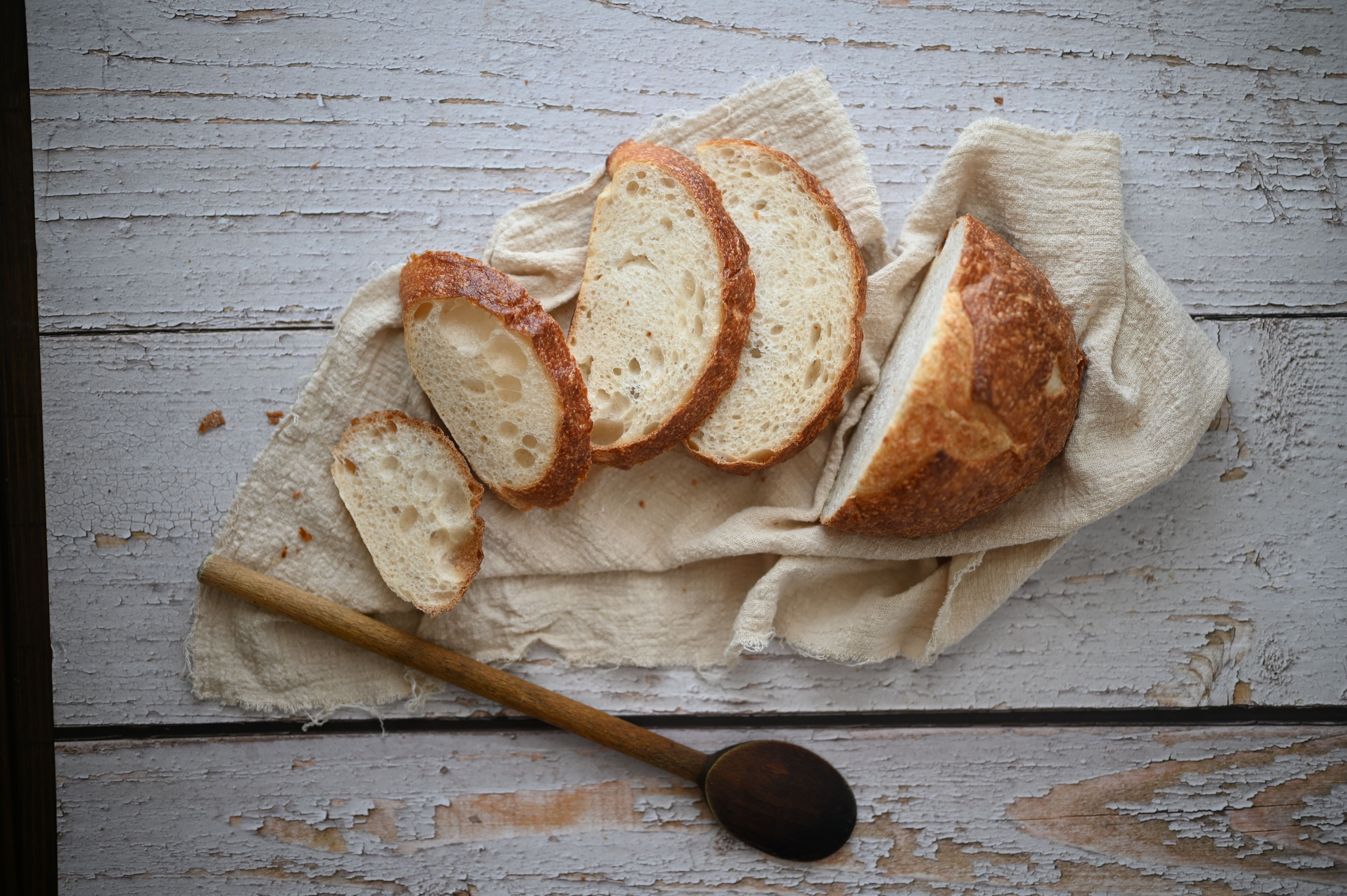 Artisan breads on linen cloth with sliced loaf and crusty texture