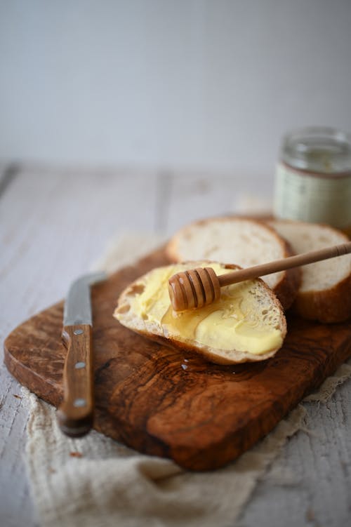 Free Bread with Honey on Cutting Board Stock Photo