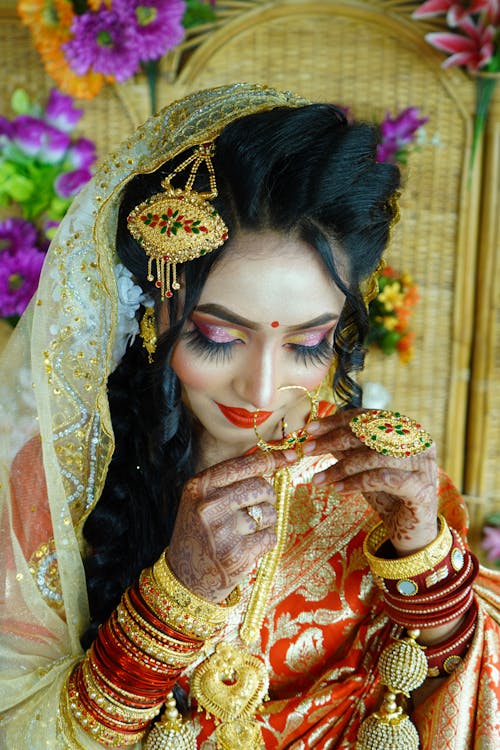 A Bride Wearing Lots of Gold Jewelries