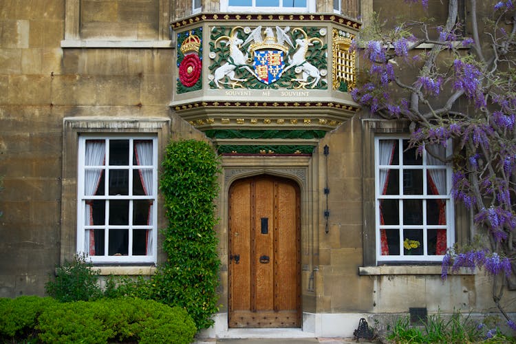 Brown Wooden Door With The Cambridge Royal Seal Above