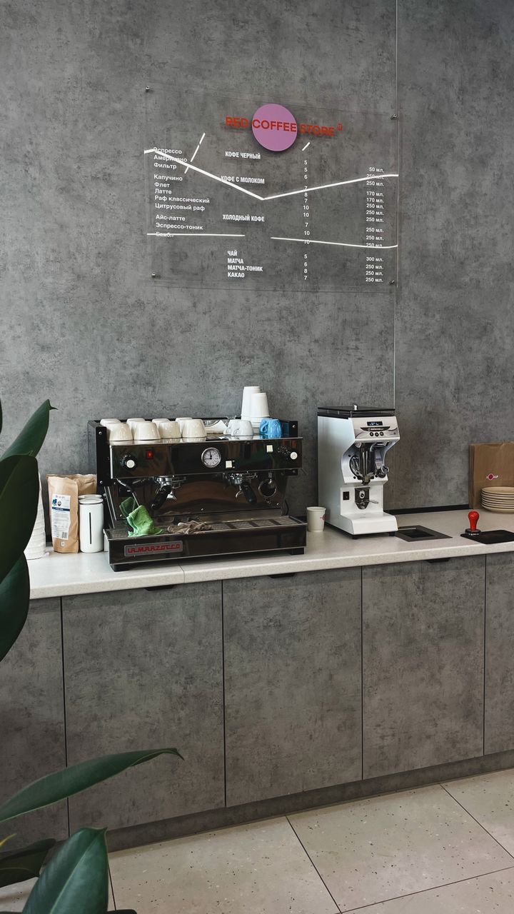 Small magnetic menu board mounted on the wall next to a modern office coffee bar