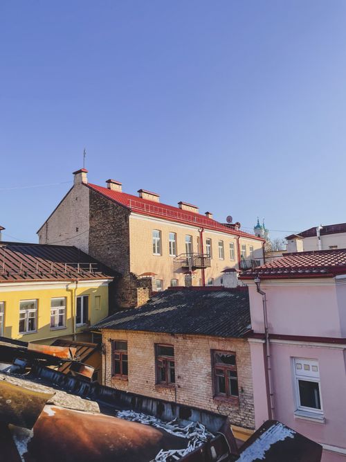 Free A view of colorful historic buildings and rooftops under a clear blue sky in Ukraine. Stock Photo