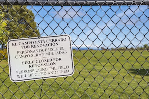 Free Warning Sign on Gray Chain Link Fence  Stock Photo