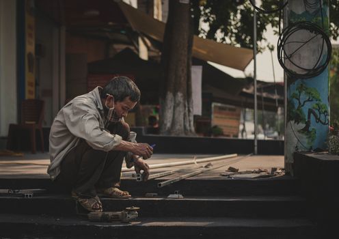 A Man Working on Tubular Steel
