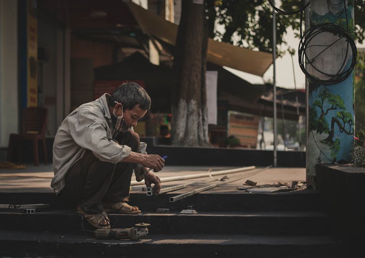 A Man Working On Tubular Steel