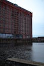 Brown Concrete Building Near Body of Water