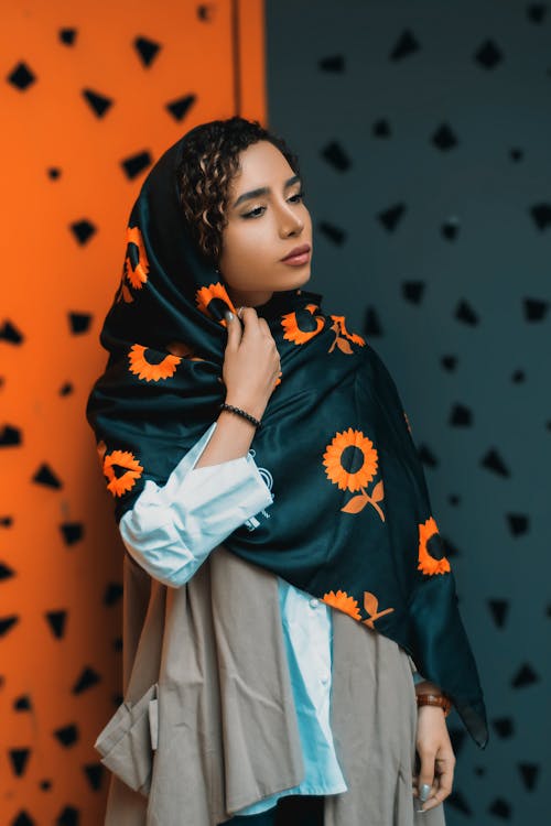 A Woman in Black and Orange Floral Hijab