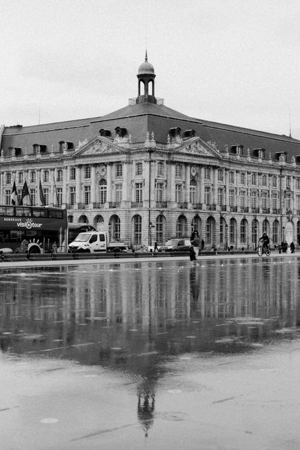Black and white photo of Place de la Bourse with water reflection in Bordeaux, France.
