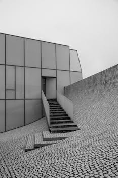 Explore minimalist modern architecture showcasing a sleek staircase and geometric design.