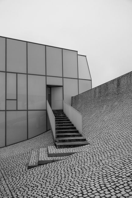 Explore minimalist modern architecture showcasing a sleek staircase and geometric design.