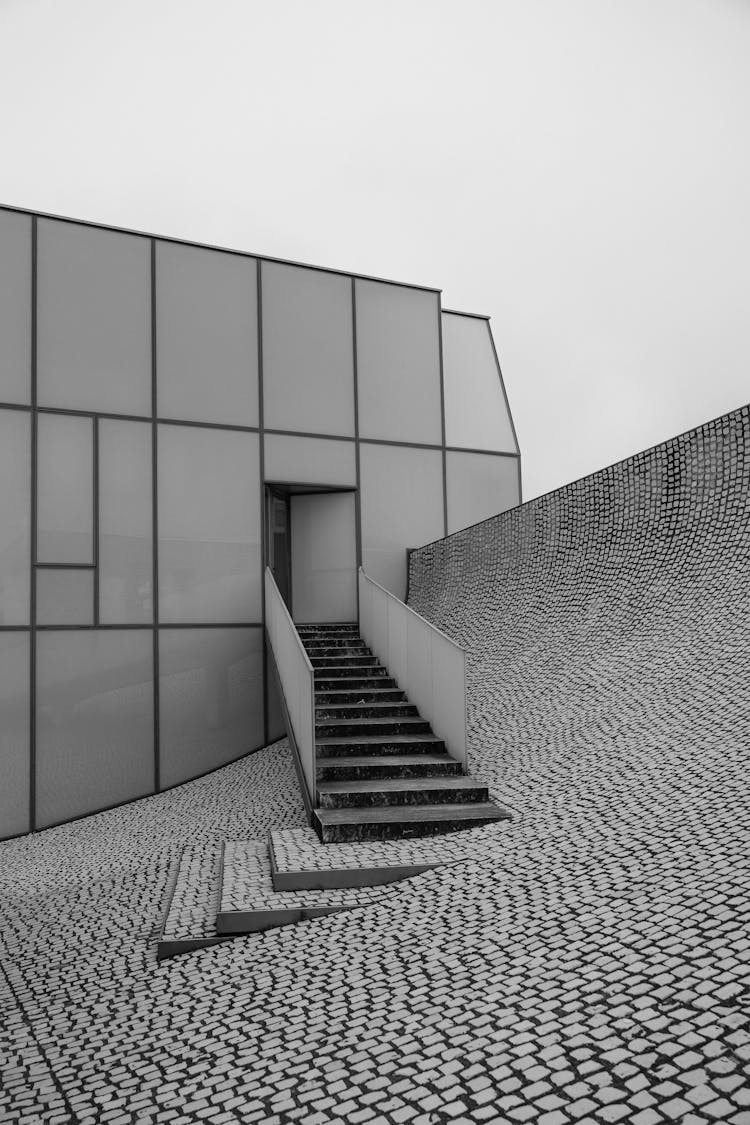 Black And White Photo Of Staircase Leading Towards Slope