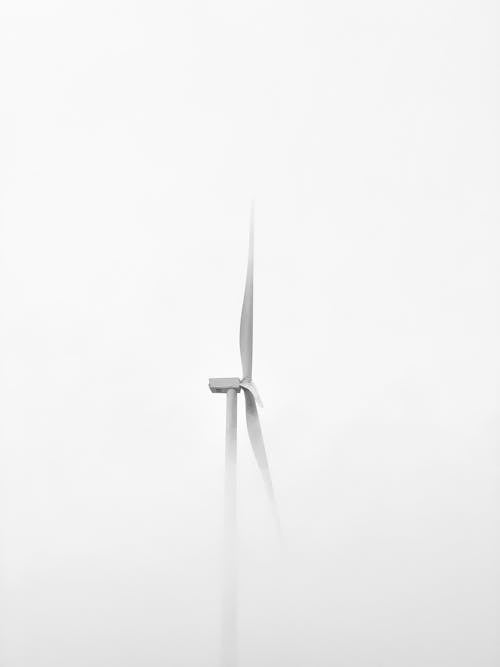 White Wind Turbine Under White Sky