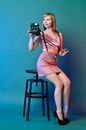Woman in Pink Sleeveless Dress Holding Black Camera