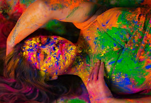 Close-up of a person covered in bright Holi festival powders, embodying creativity and vivid artistry.