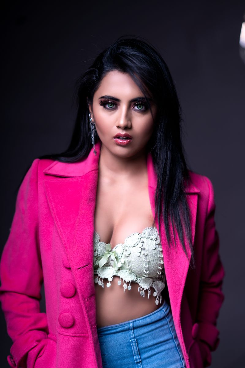 Stylish portrait of a woman in a pink blazer with a fashionable look.