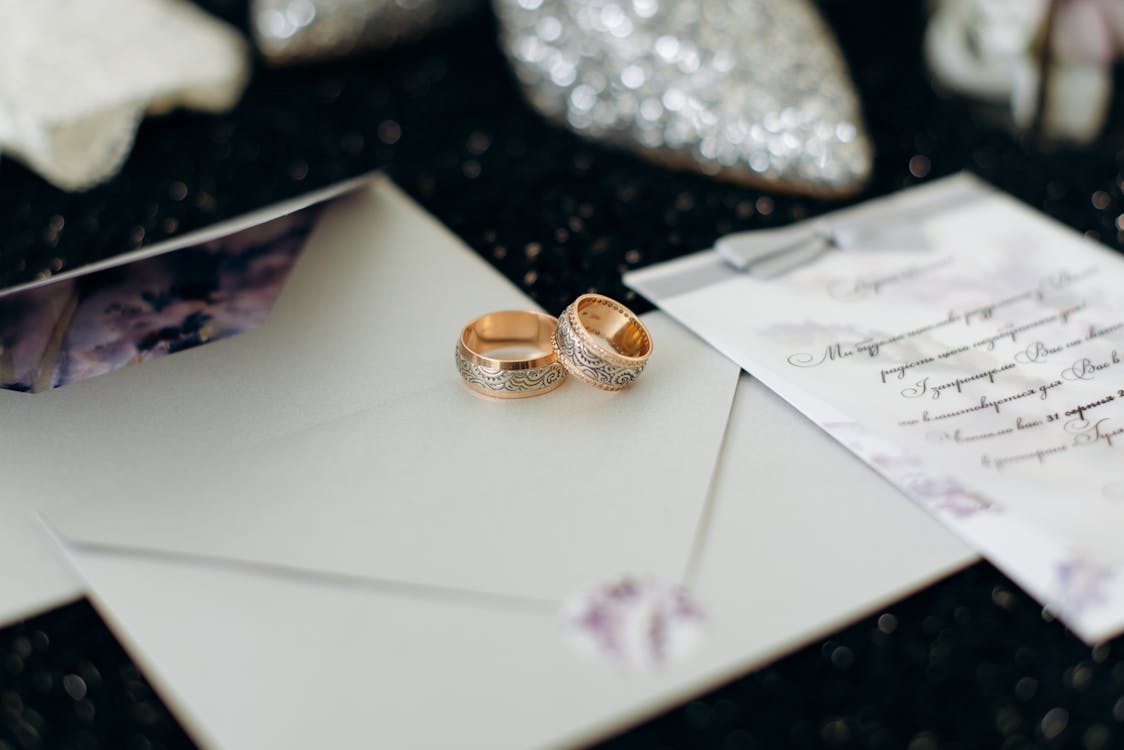 Gold Wedding Rings on White Envelope · Free Stock Photo