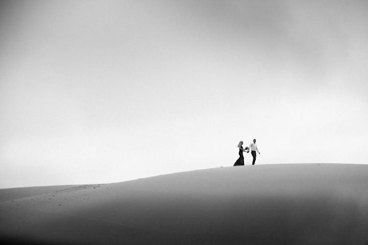 Couple Roaming Through Desert