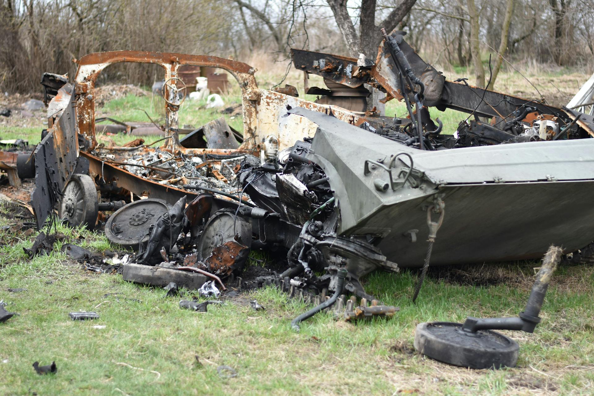 Wrecked Car on Green Grass Field