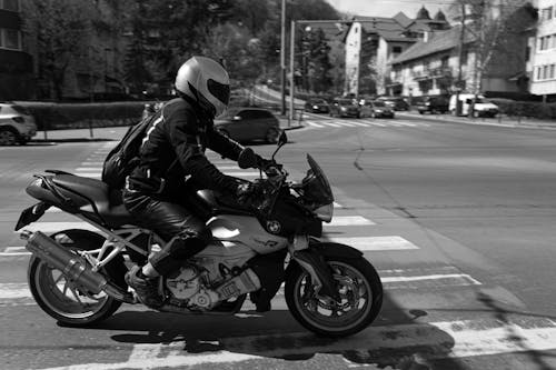 Free Grayscale Photo of a Person Riding a Motorcycle on the Road Stock Photo