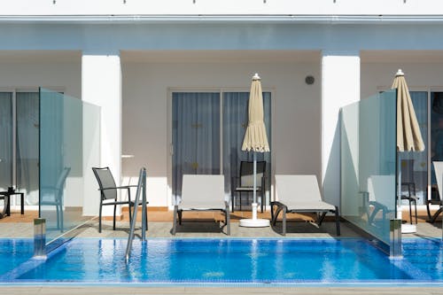 Blue Swimming Pool Near Black Chairs