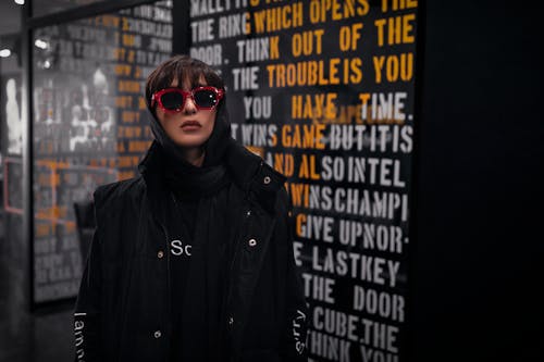 Woman Wearing Black Jacket and Red Framed Sunglasses