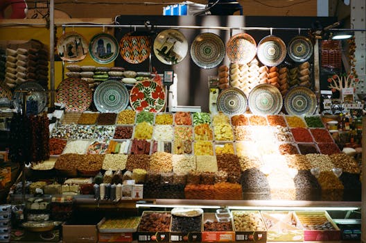 Colorful display of spices, nuts, and dishes at a Kyiv market stall.