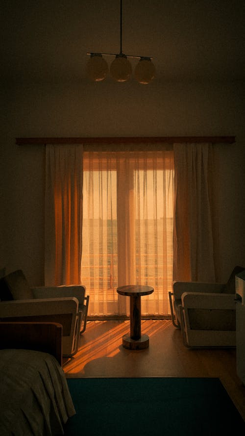 Free Brown Window Curtain Near Brown Wooden Armchair Stock Photo