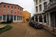A Vintage Car Parked BesideWhite Concrete Building