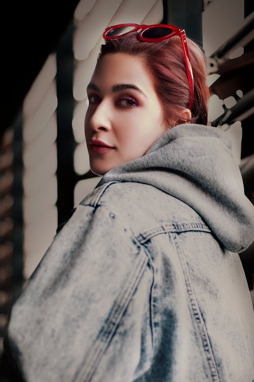 A Woman in Denim Jacket Looking at the Camera