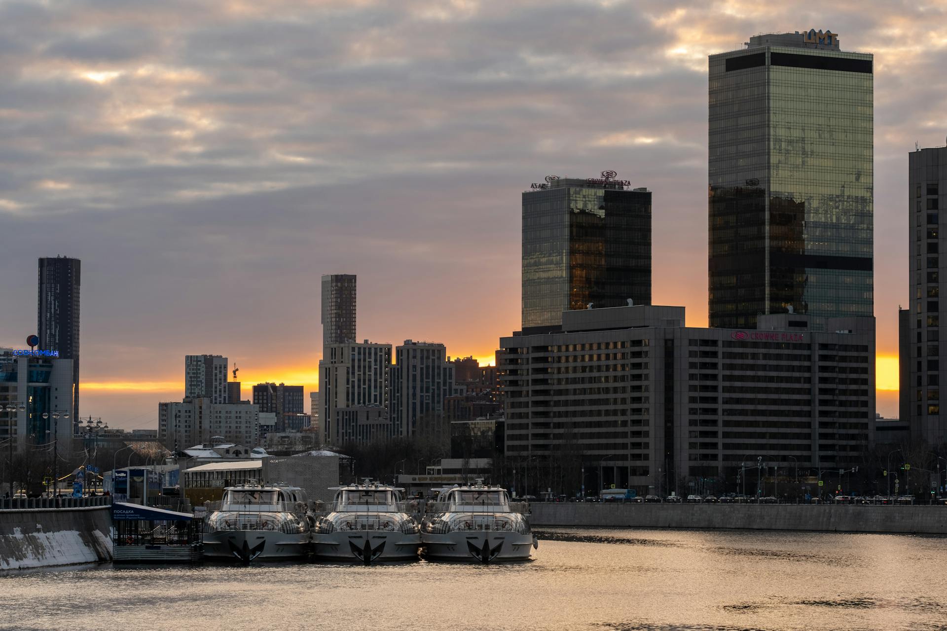 Ferry Boats Docked at the Bay Near City Buildings