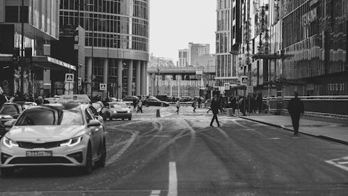 Black and White Photo of a Busy Street and Modern Buildings in City
