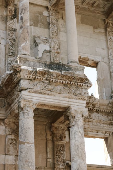 Close-up of ancient Roman ruins featuring detailed ornate columns and stone carvings.