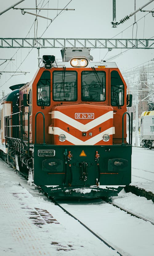 Red and White Train on Rail Tracks