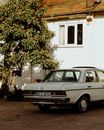 Blue Sedan Parked Beside Green Tree