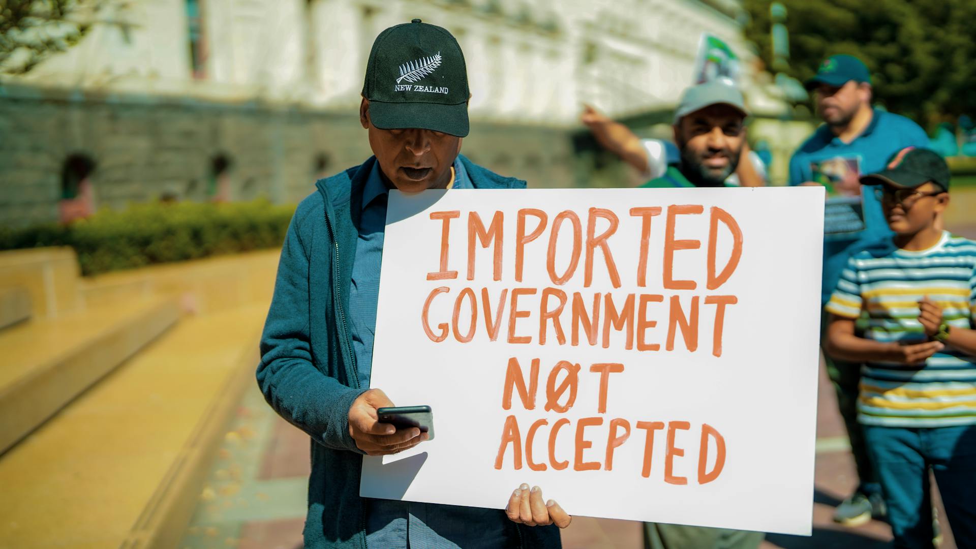 Man Holding a Banner with a Message about Government