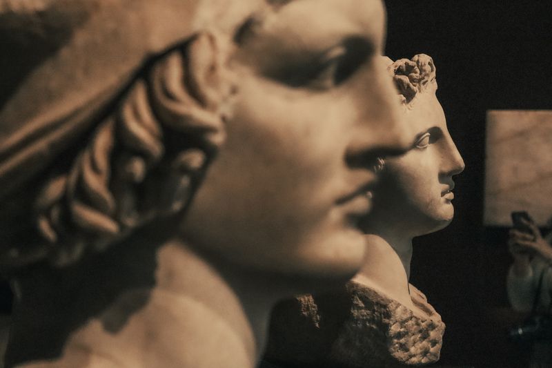 Classical marble busts in warm museum light