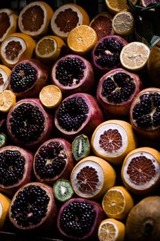 A colorful close-up of assorted fresh fruits including citrus and pomegranate.