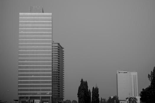 A black and white photograph showcasing modern skyscrapers against a clear sky.