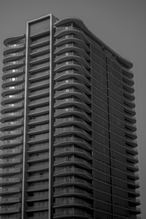 Free Black and white photo of a modern skyscraper with curved balconies. Stock Photo