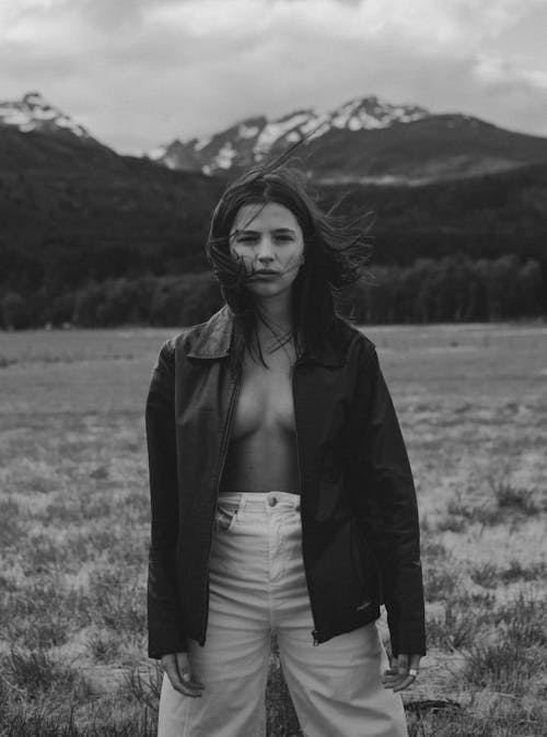 Free Woman Posing on a Field in Jacket Shirtless  Stock Photo