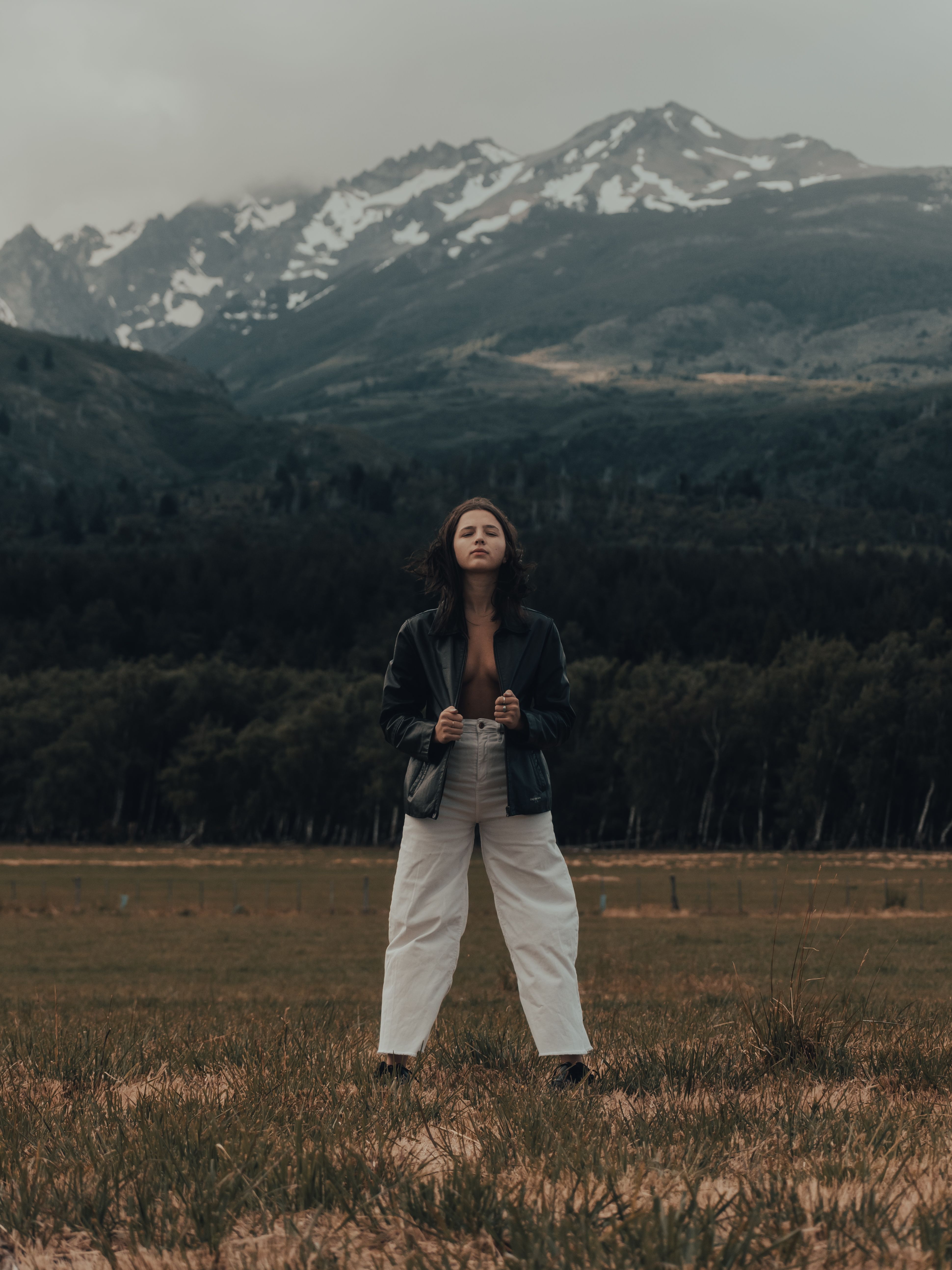 Woman in Black Jacket Standing on Brown Grass Field · Free Stock Photo