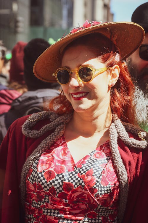 Woman in Red Floral Dress Wearing Brown Sun Hat and Round Sunglasses