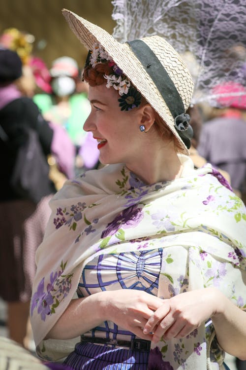 Woman Wearing Sun Hat and Floral Scarf Looking Over Shoulder