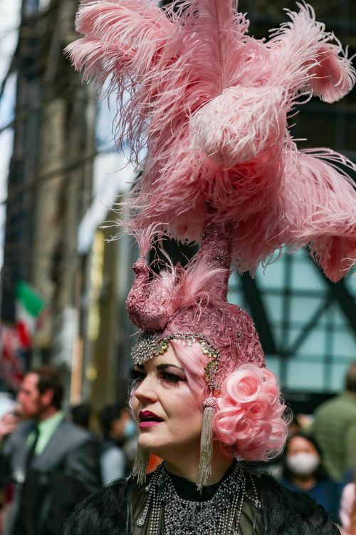 Free A colorful portrait of a woman in fancy pink headwear during a street festival. Stock Photo