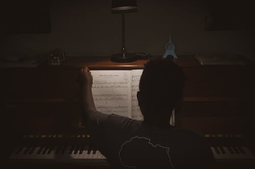 Free Photo of Person Sitting In Front Of Piano Stock Photo