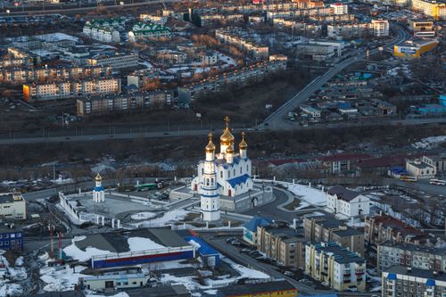 Free A stunning aerial view of an Orthodox church surrounded by urban landscapes, showcasing architectural beauty. Stock Photo