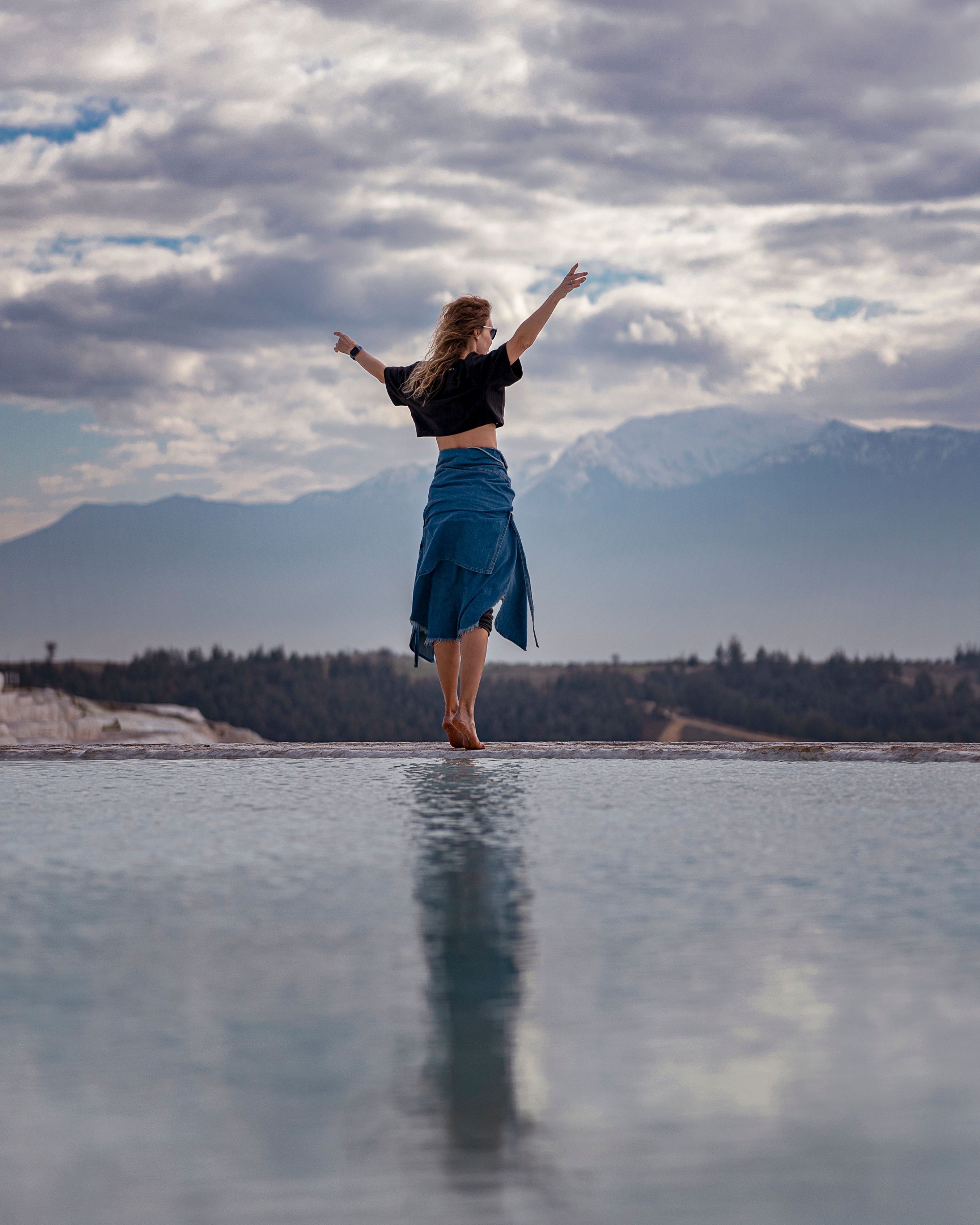 Woman in Black Crop Top Standing Near Body of Water · Free Stock Photo