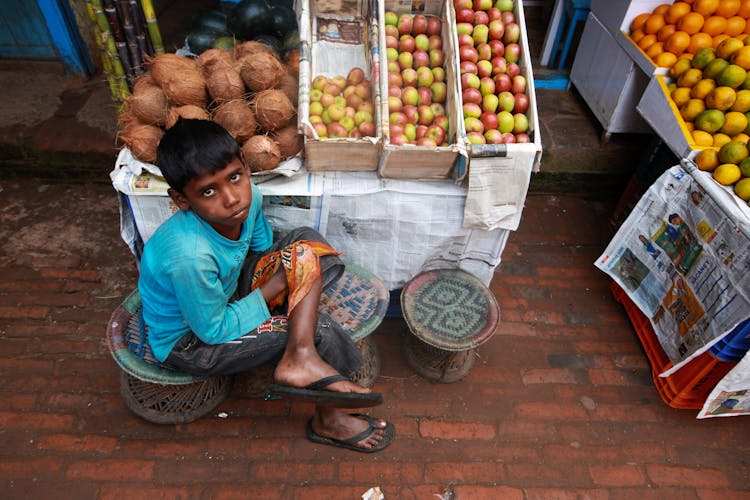 Boy Selling Fruits In The Market