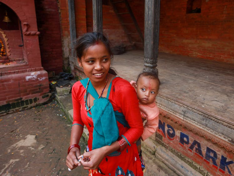 Woman Carrying A Baby On Her Back 