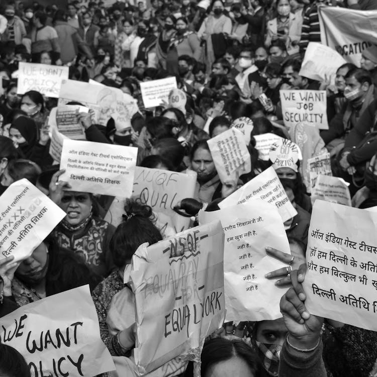 Grayscale Photo Of People Holding White Print Paper